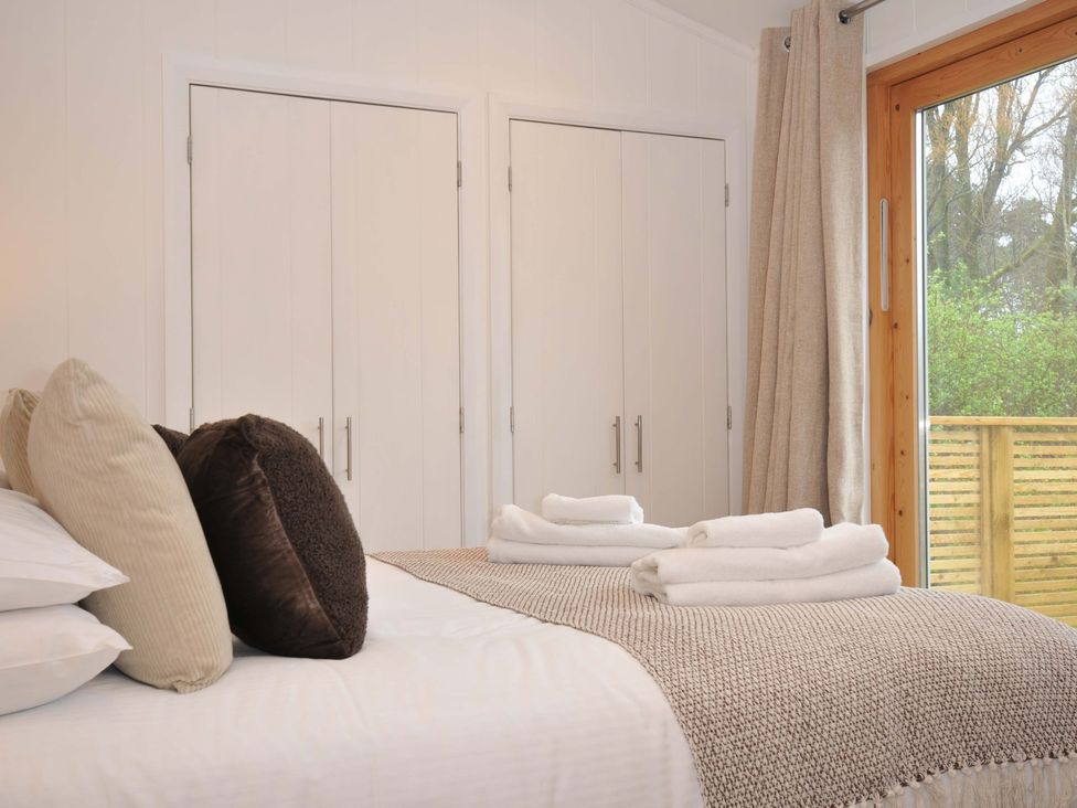 A bedroom with a bed and wardrobe at 4 Southern Place in Dobwalls