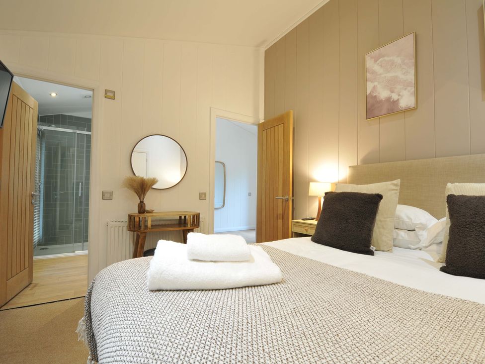 A bedroom with a bed and mirror at 4 Southern Place in Dobwalls