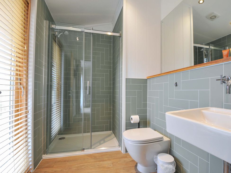 A bathroom with a shower, toilet and sink at 4 Southern Place, Dobwalls