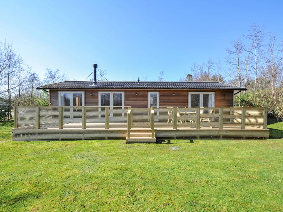 A house with a deck and grass area at 4 Southern Place in Dobwalls