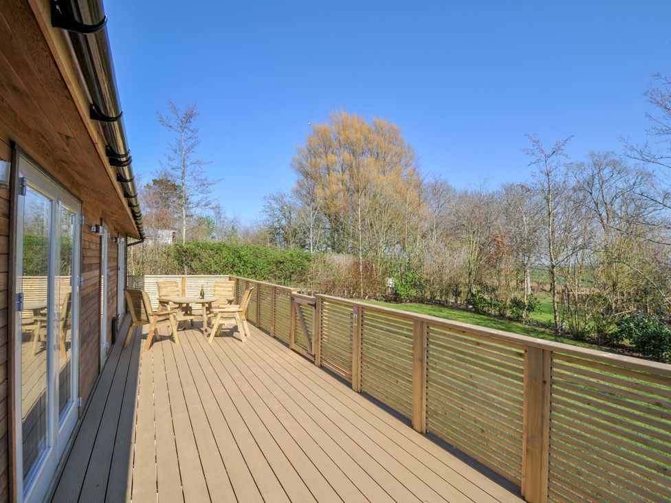 An outdoor area with a deck and table set at 4 Southern Place in Dobwalls