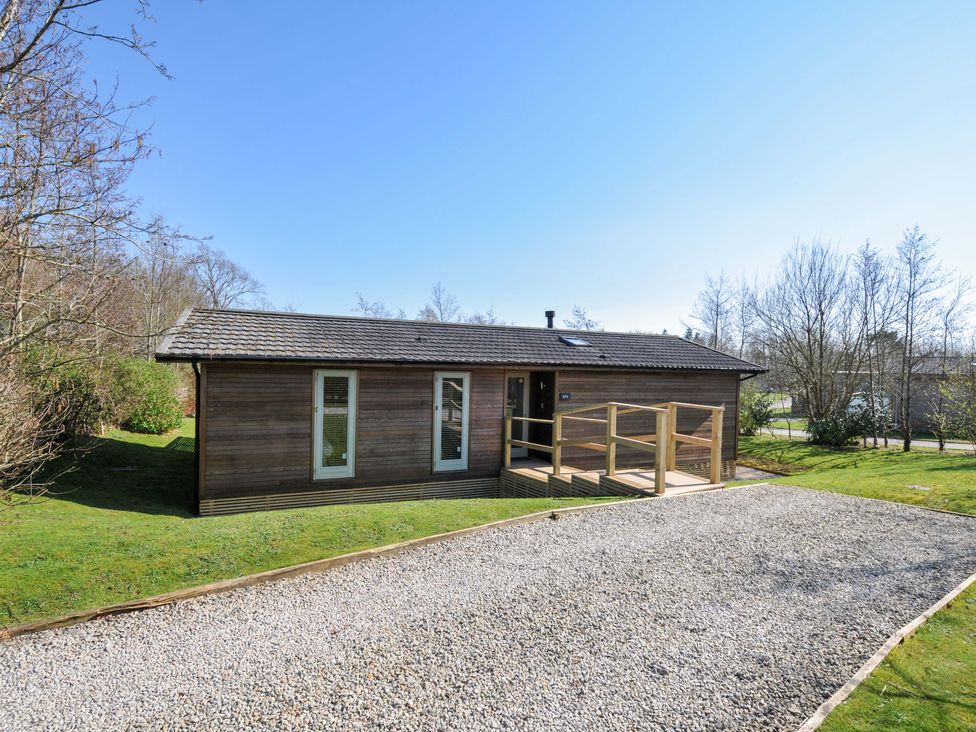 A wooden house with a deck and gravel path at 4 Southern Place in Dobwalls