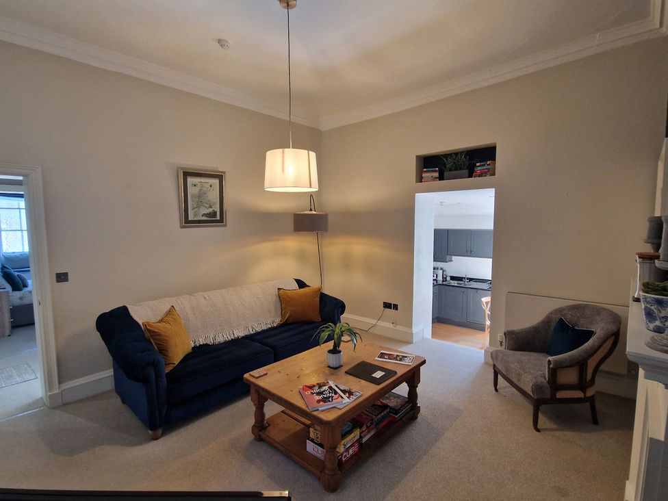 A living room with a sofa and coffee table at Flat 3 in Ross-on-Wye