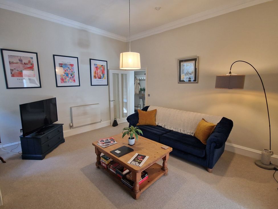 A living room with a television and sofa at Flat 3 in Ross-on-Wye