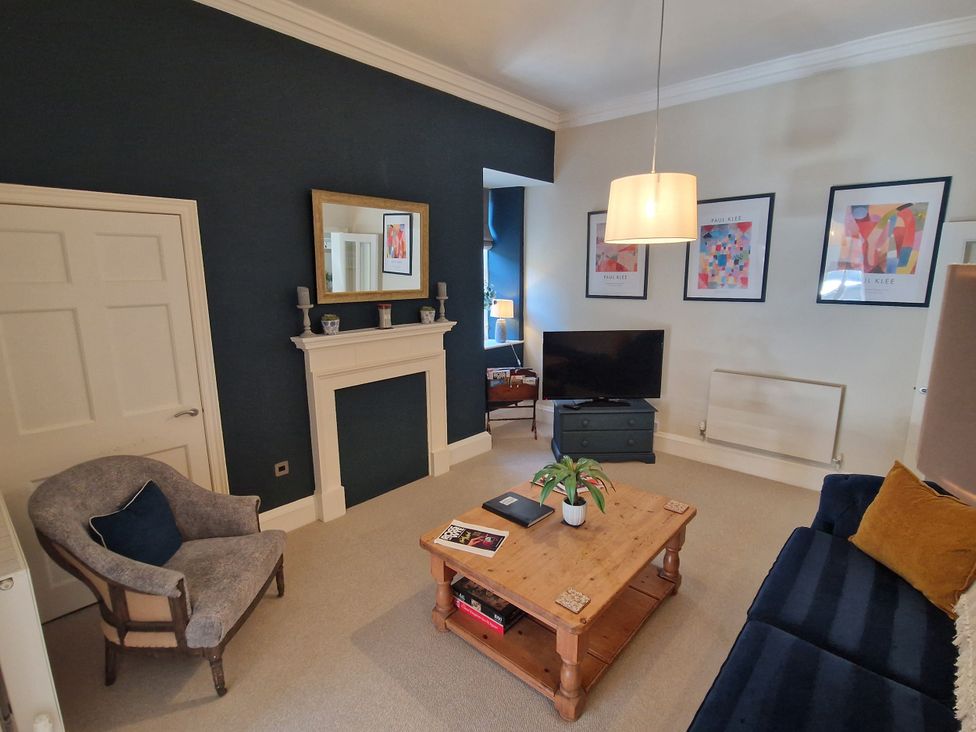 A living room with a sofa and coffee table at Flat 3 in Ross-on-Wye