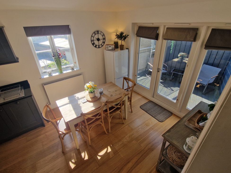 A kitchen with a dining table and chairs at Flat 3 in Ross-on-Wye