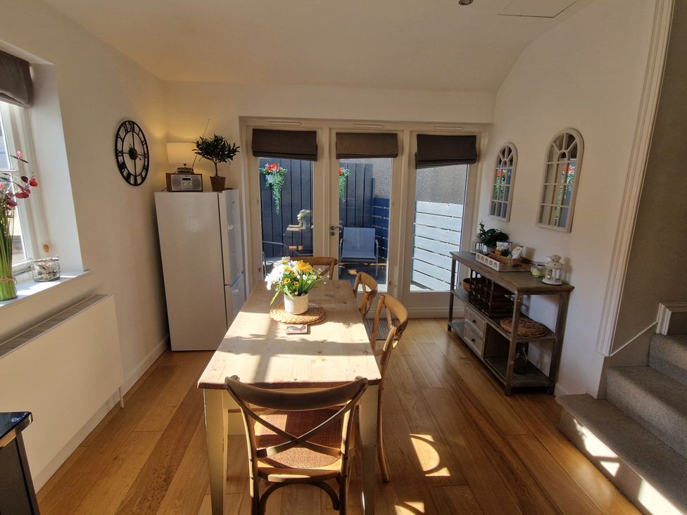 A dining room with a table and chairs at Flat 3 in Ross-on-Wye