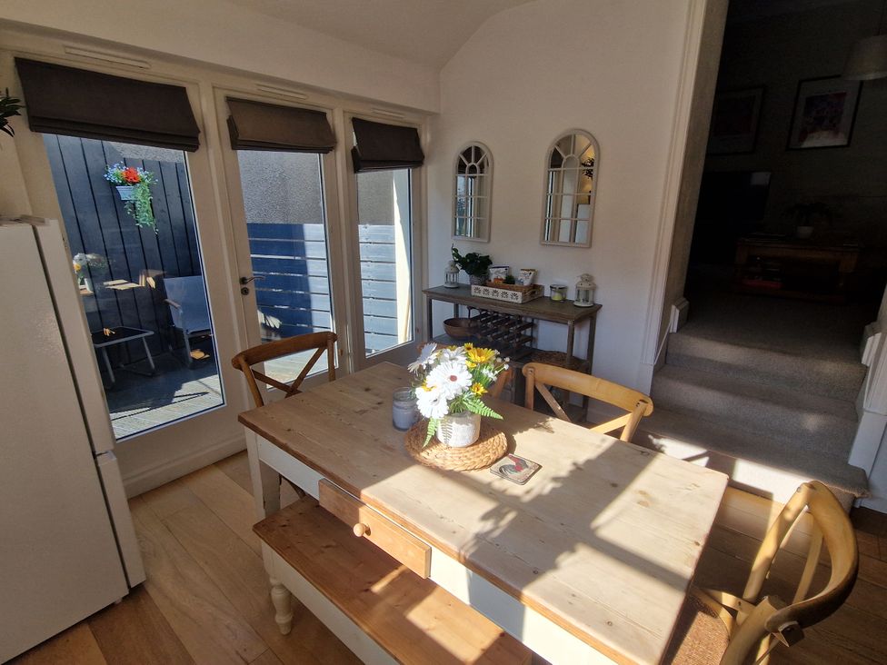 A dining room with a wooden table and chairs at Flat 3 in Ross-on-Wye