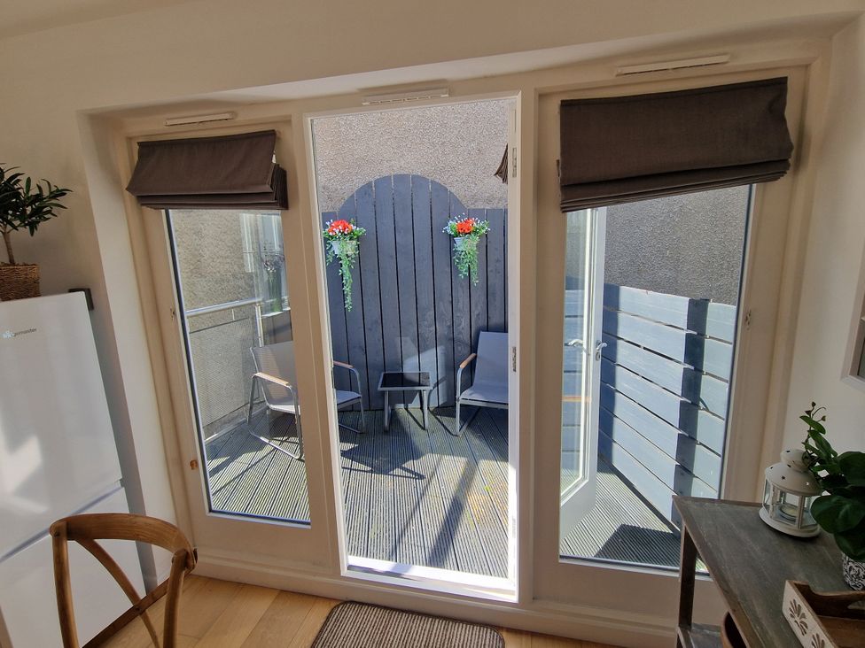 A balcony with chairs and a table at Flat 3 in Ross-on-Wye