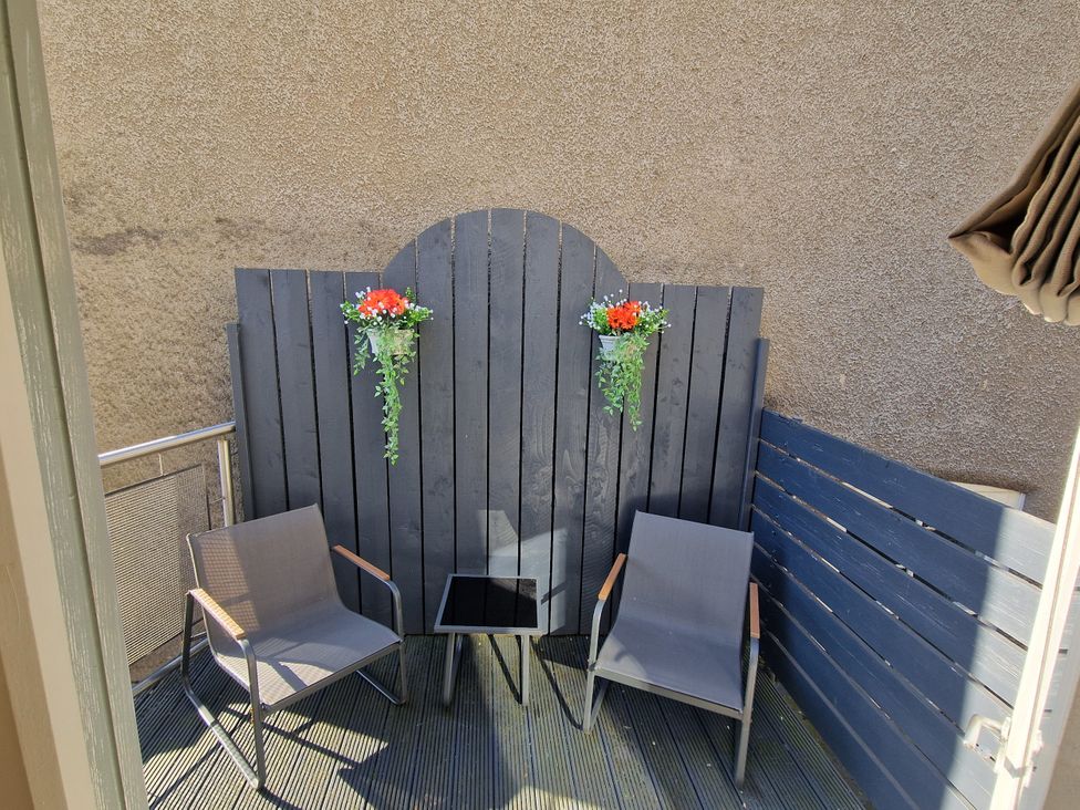 A balcony with chairs and a small table at Flat 3 in Ross-on-Wye