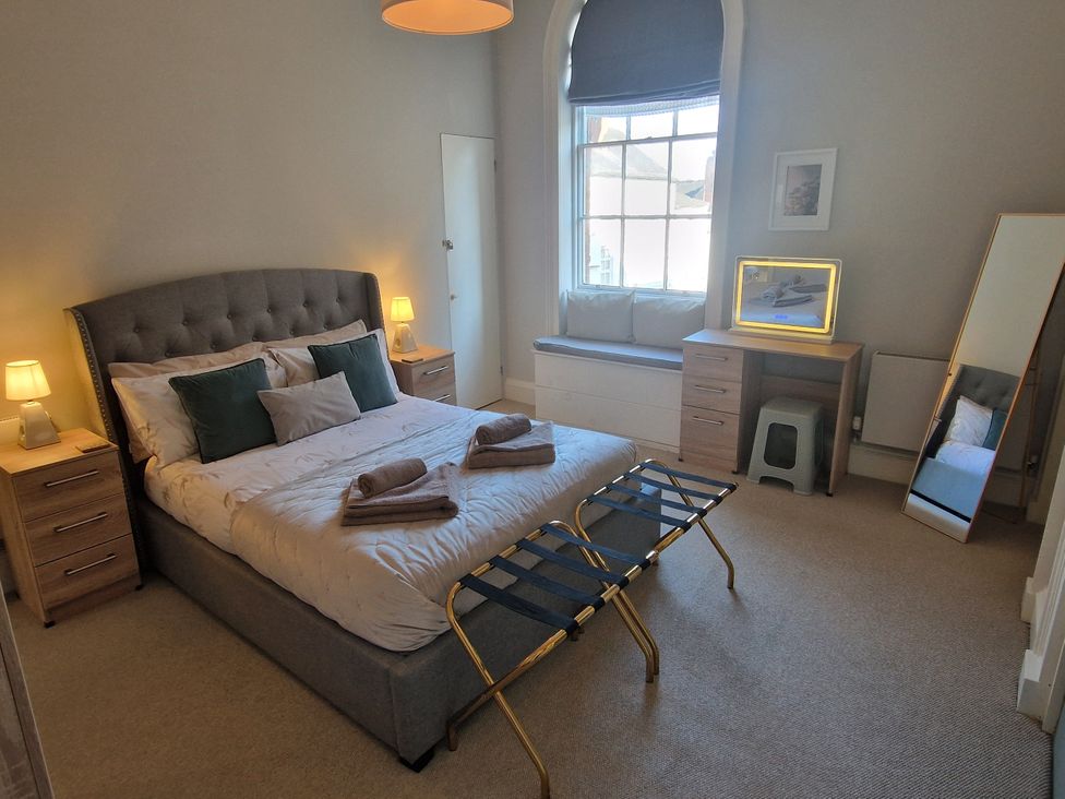 A bedroom with a bed and nightstands at Flat 3 in Ross-on-Wye