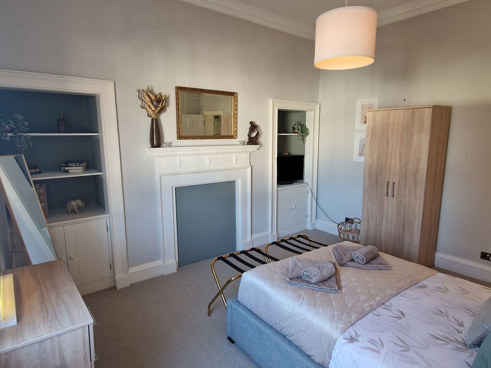 A bedroom with a bed and wardrobe at Flat 3 in Ross-on-Wye