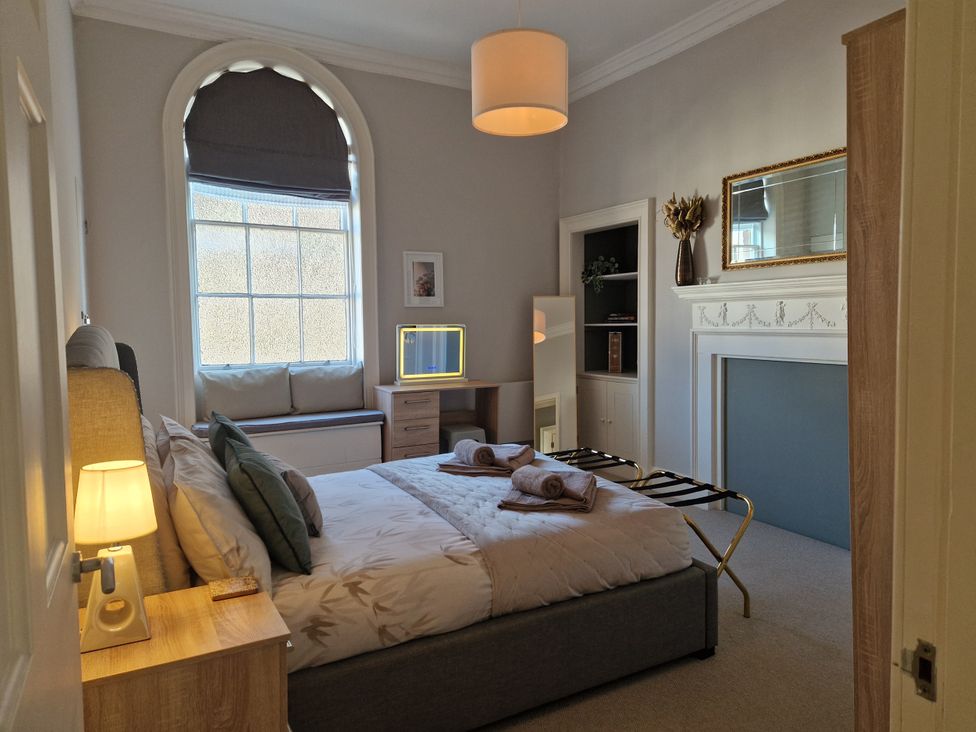 A bedroom with a bed and a window seat at Flat 3 in Ross-on-Wye
