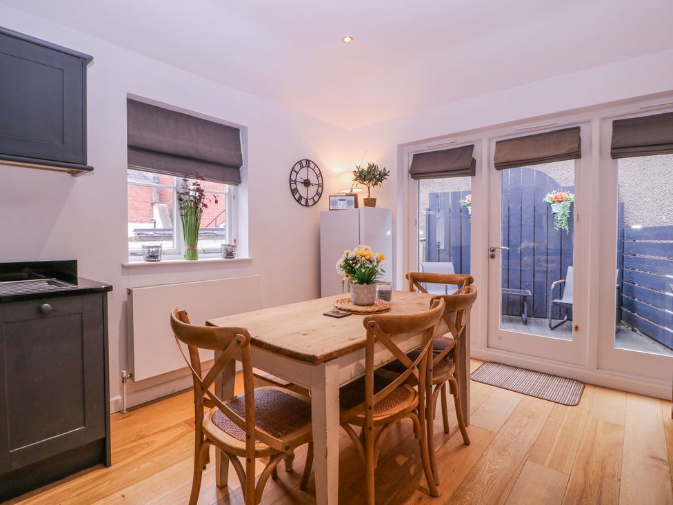 A kitchen with a dining table and chairs at Stylish Town Apartment in Ross-On-Wye