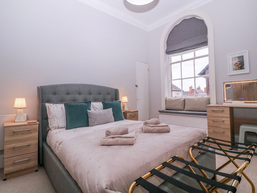A bedroom with a bed and nightstands at Stylish Town Apartment in Ross-On-Wye