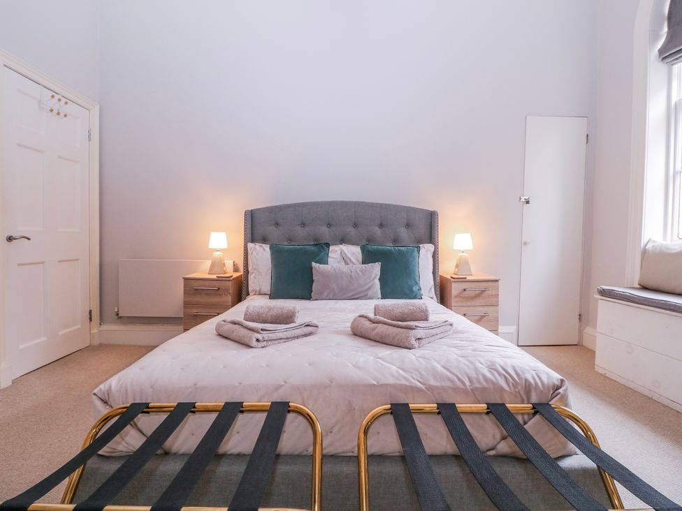 A bedroom with a bed and bedside tables at Stylish Town Apartment in Ross-On-Wye