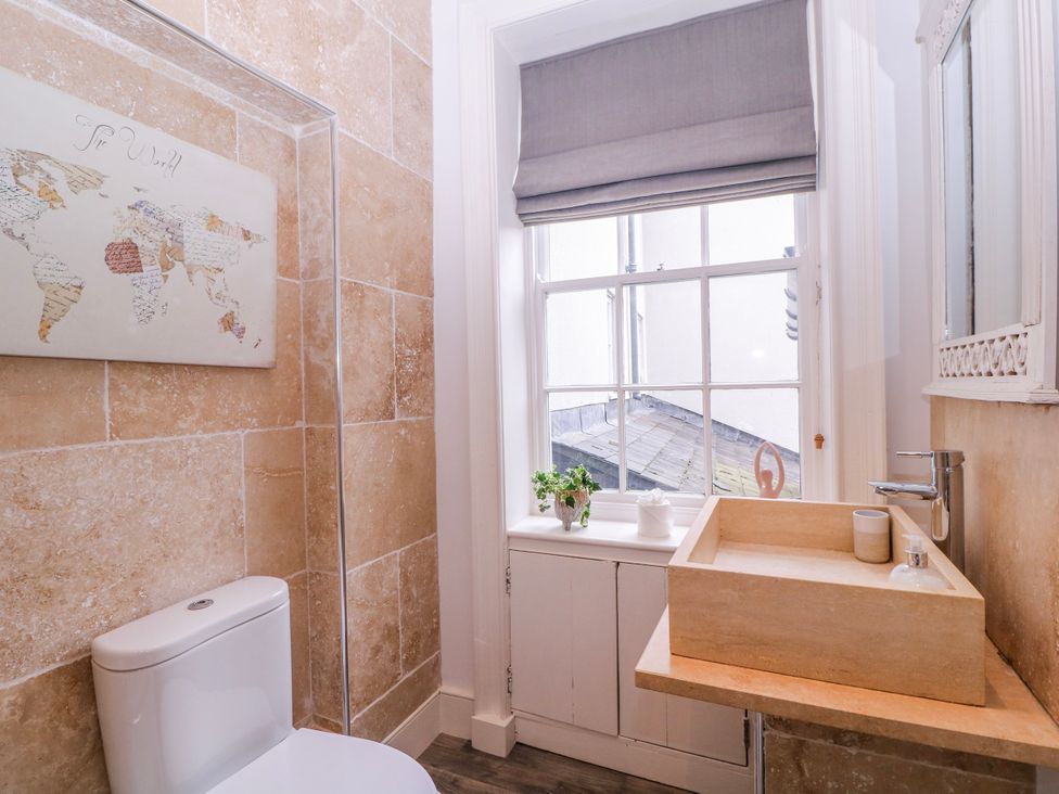 A bathroom with a toilet and washbasin at Stylish Town Apartment in Ross-On-Wye