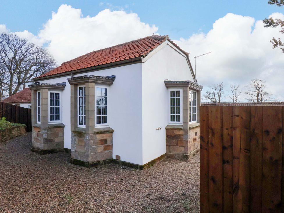 A house with a red roof and windows in the garden at Little Acorn in Whitby