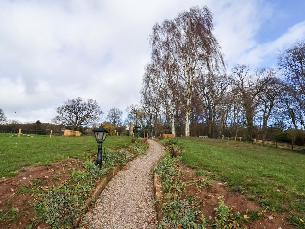 A pathway with a lamp post and trees at Little Acorn in Whitby