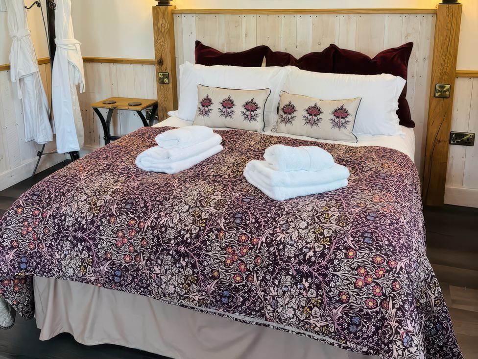A bedroom with a bed and towels arranged at Little Acorn in Whitby