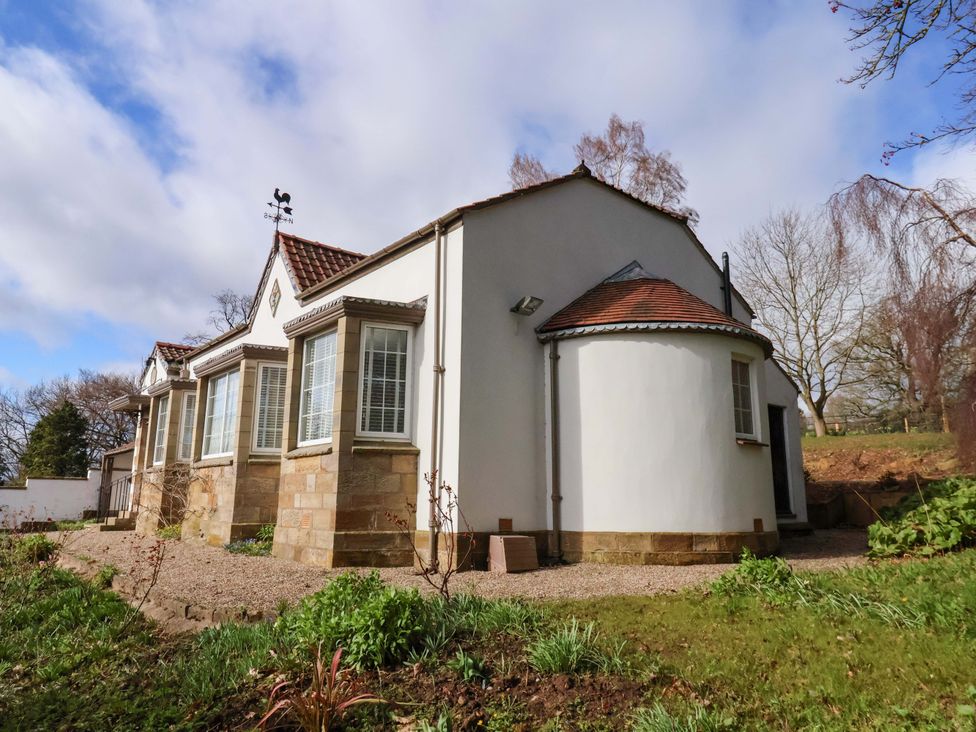 An exterior view of a house with a garden at Hawthorn Lodge in Whitby