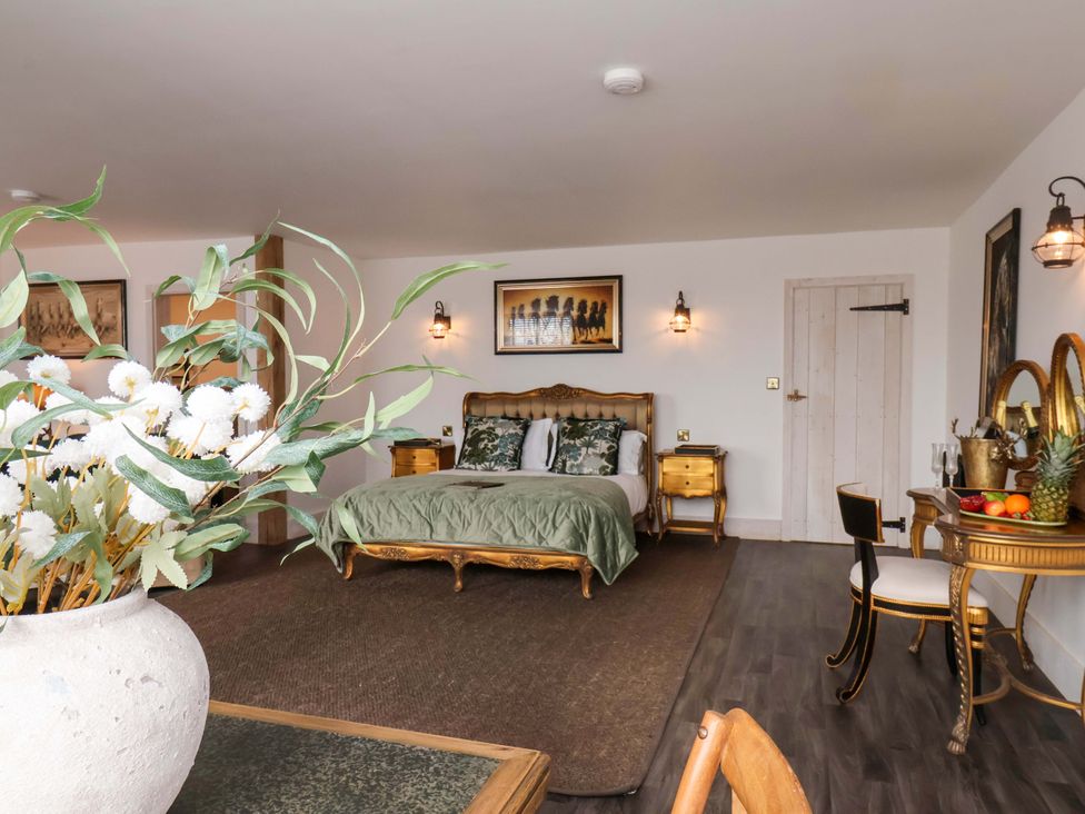 A bedroom with a bed and desk at Hawthorn Lodge in Whitby