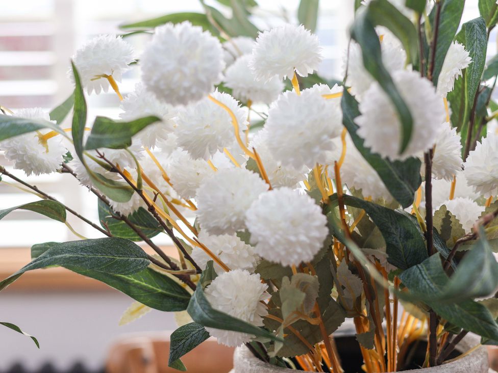 A floral arrangement with white flowers and green leaves at Hawthorn Lodge in Whitby