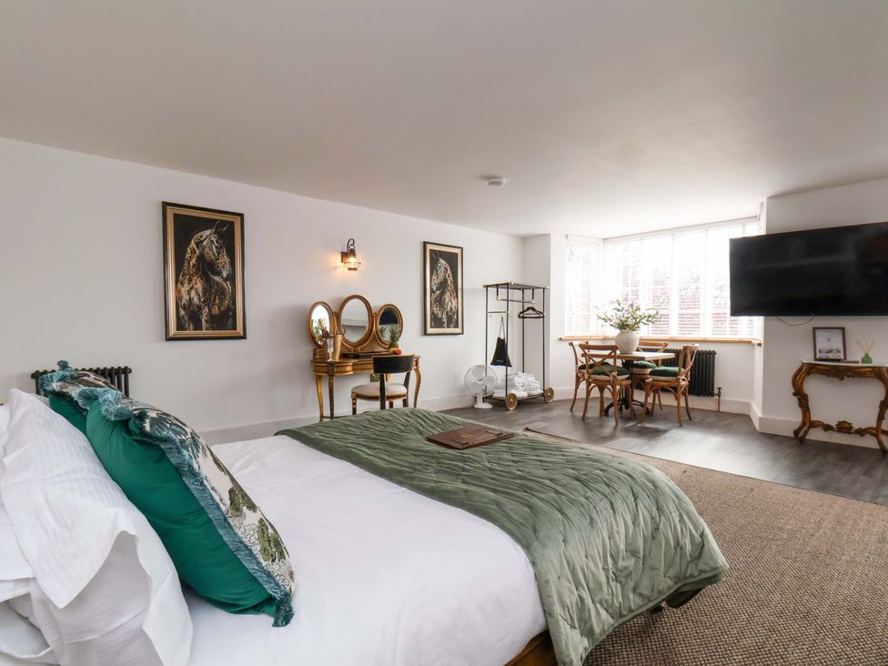 A bedroom with a bed and seating area at Hawthorn Lodge in Whitby
