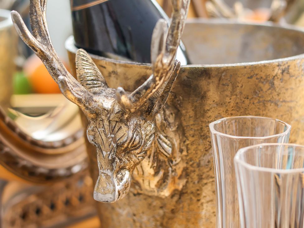 A champagne bucket with a deer head design and glasses at Hawthorn Lodge in Whitby