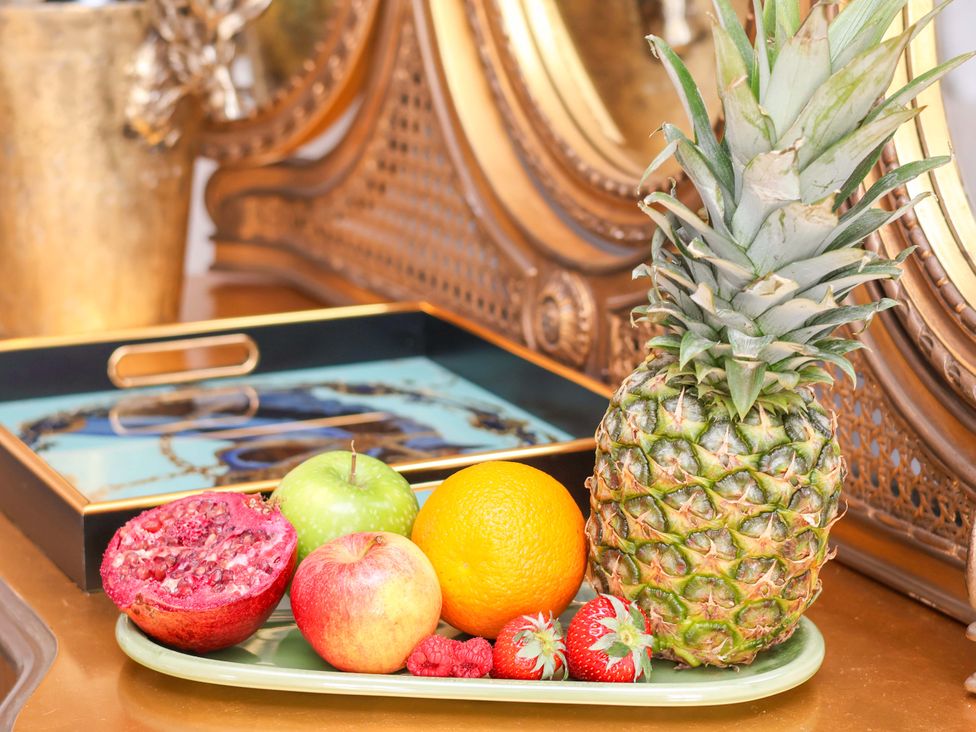 A green tray with various fruits including a pineapple and apple at Hawthorn Lodge in Whitby
