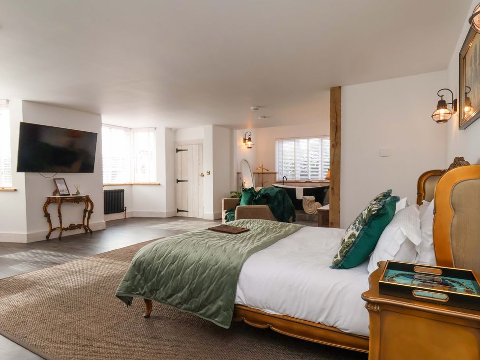 A bedroom with a bed and television at Hawthorn Lodge in Whitby