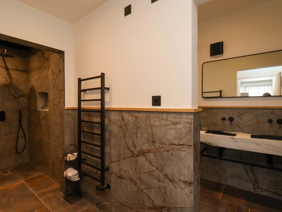 A bathroom with a shower and washbasin at Hawthorn Lodge in Whitby