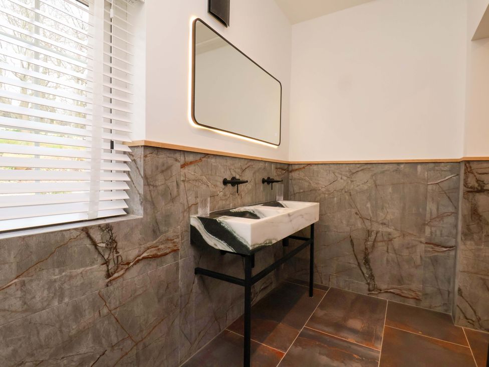 A bathroom with a sink and mirror at Hawthorn Lodge in Whitby