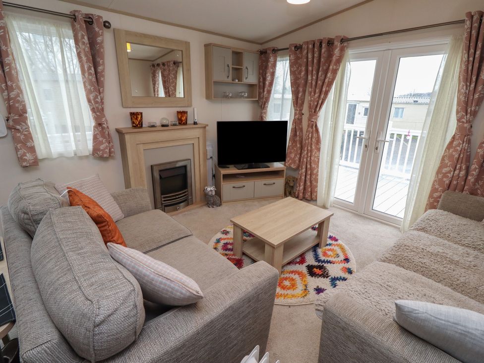 A living room with a television and sofa at Cresswell Towers 