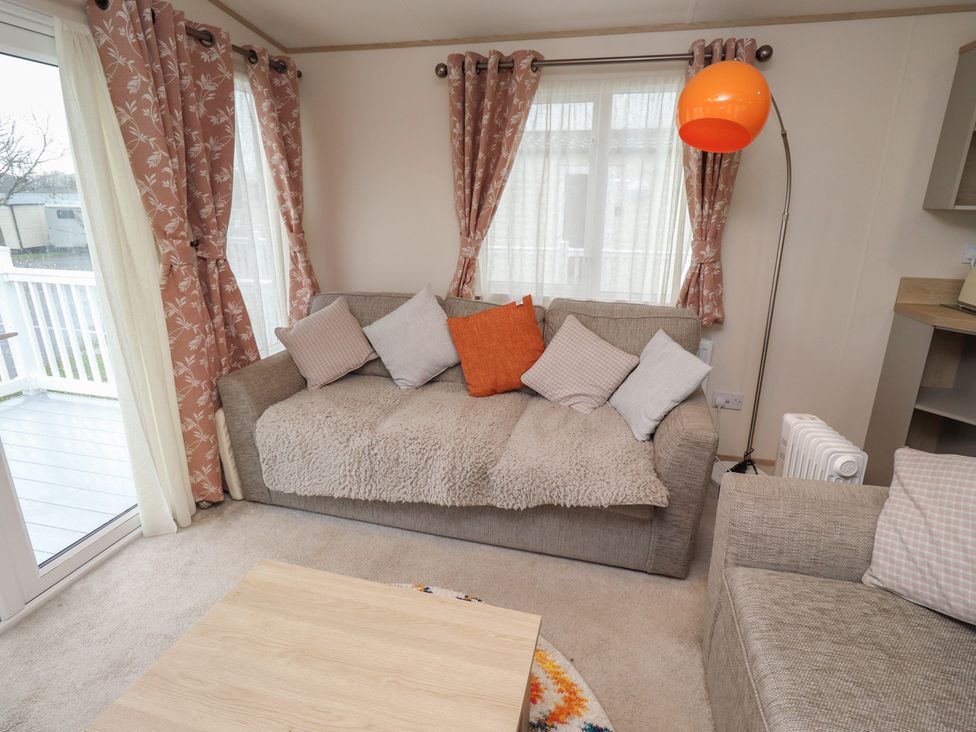 A living room with a sofa and coffee table at Cresswell Towers