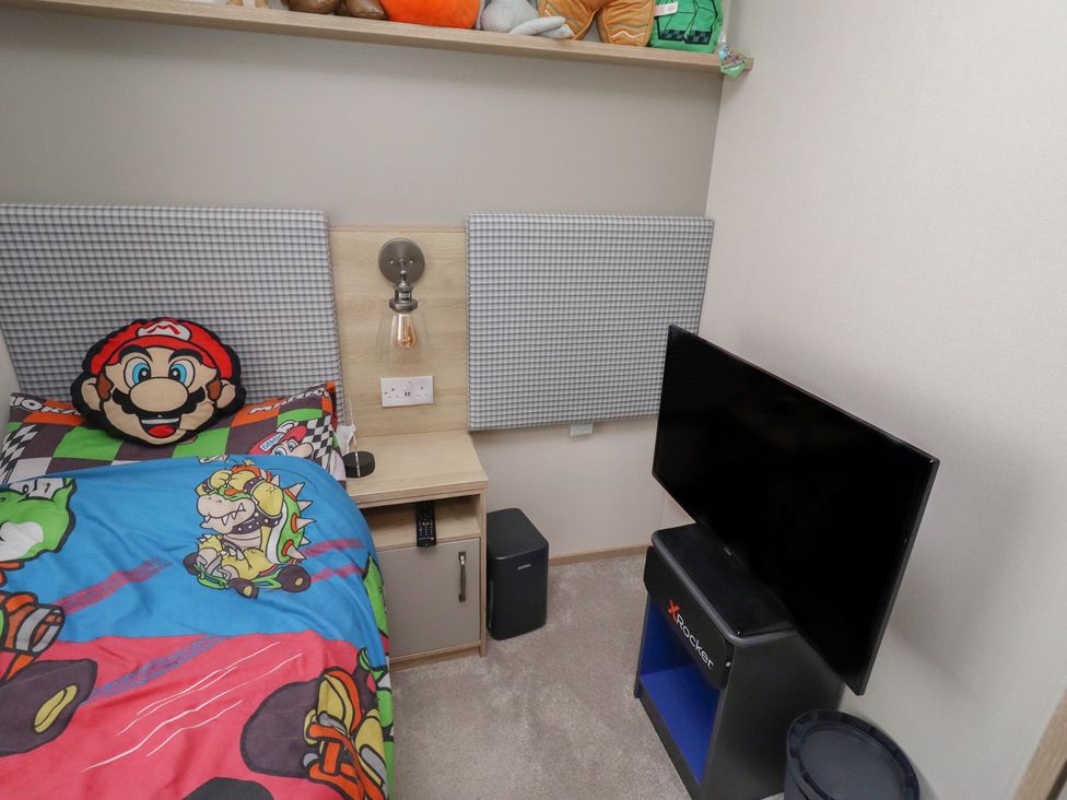 A bedroom with a bed and television at Cresswell Towers 