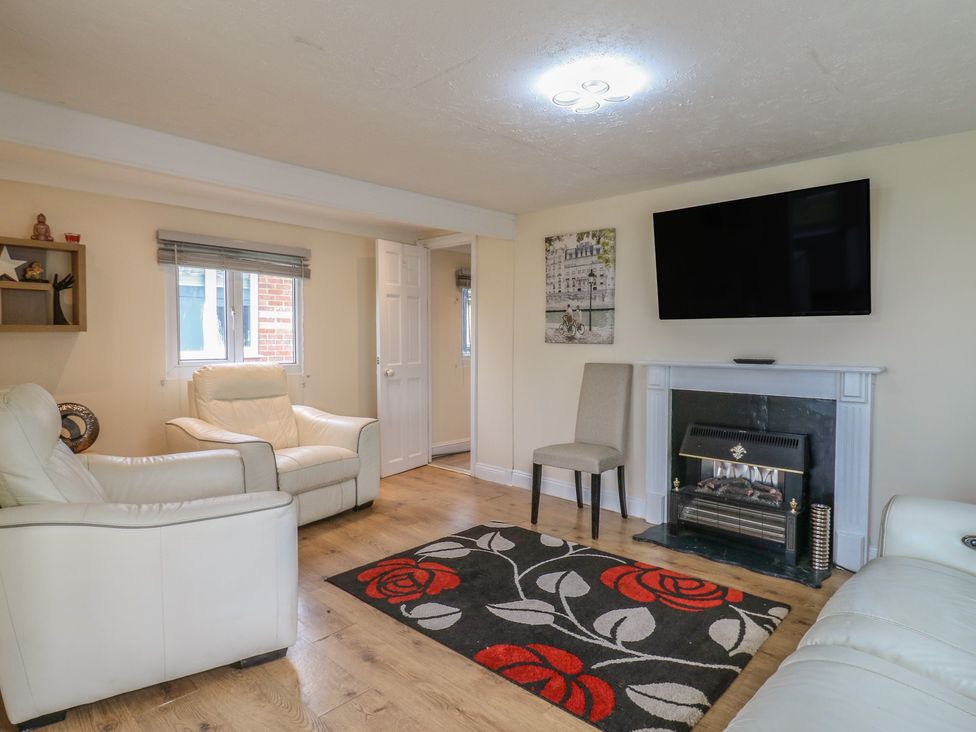 A living room with a television and fireplace at 130 Park Ave Holiday Village
