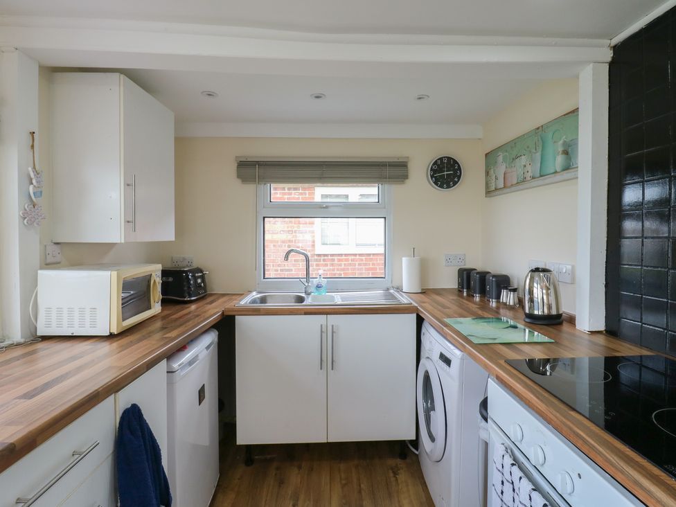 A kitchen with appliances and a sink at 130 Park Ave Holiday Village