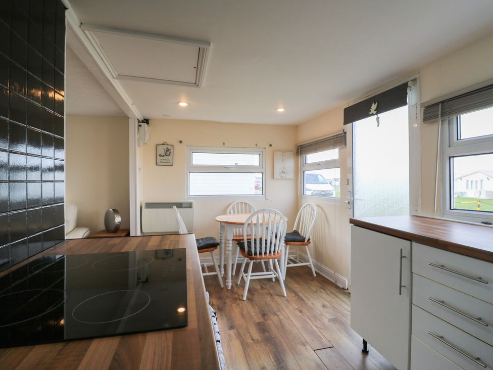 A kitchen with a dining table and chairs at 130 Park Ave Holiday Village