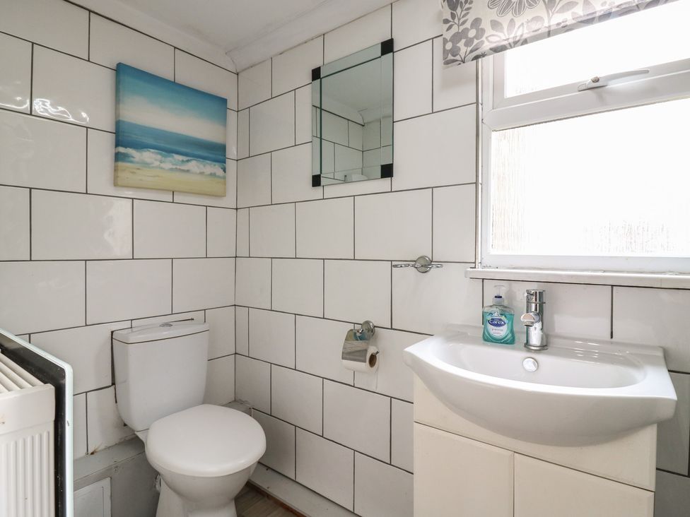 A bathroom with a toilet and sink at 130 Park Ave Holiday Village