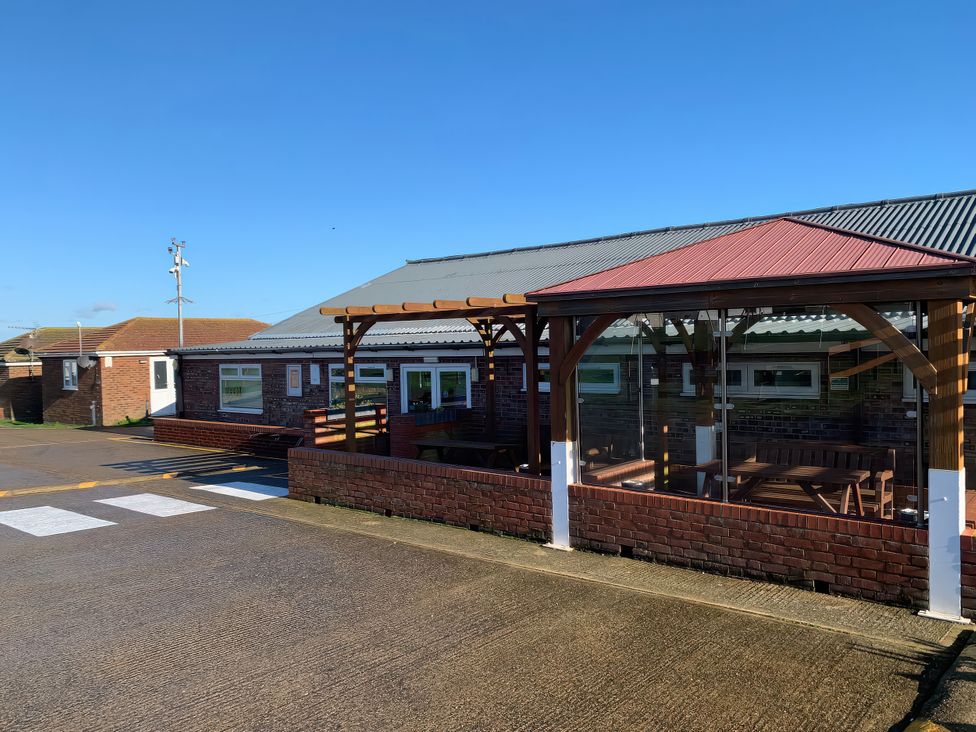 An outdoor seating area with a pergola at Salt Air 130 @ Park Ave Holiday Village, Leysdown-On-Sea, Kent