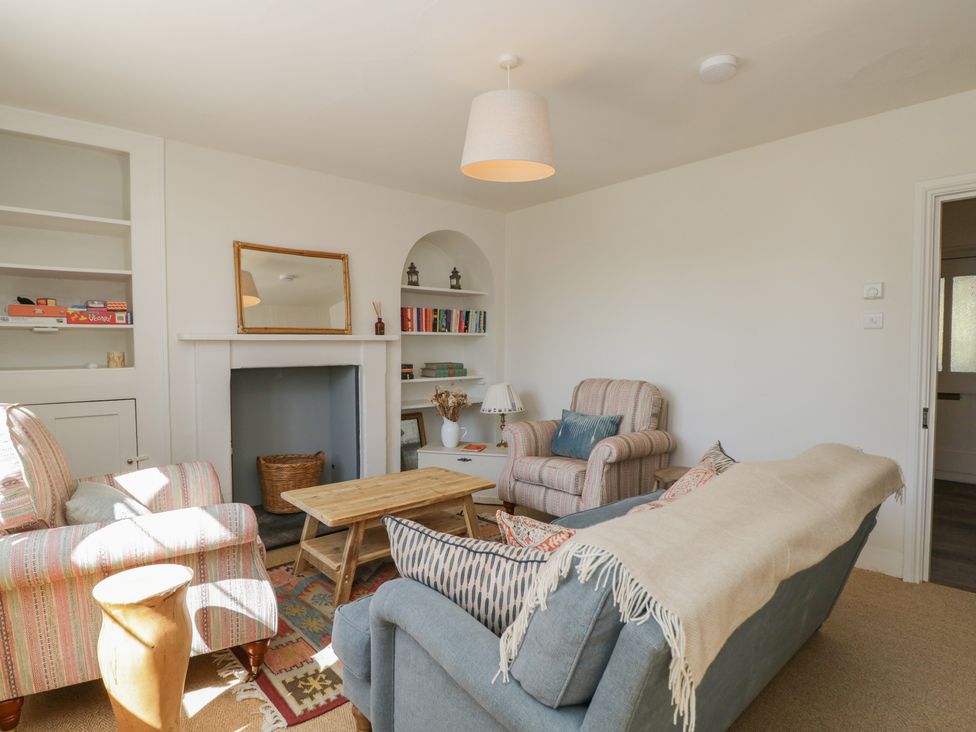 A living room with chairs and a coffee table at Middle Cottage in Tisbury, Wiltshire