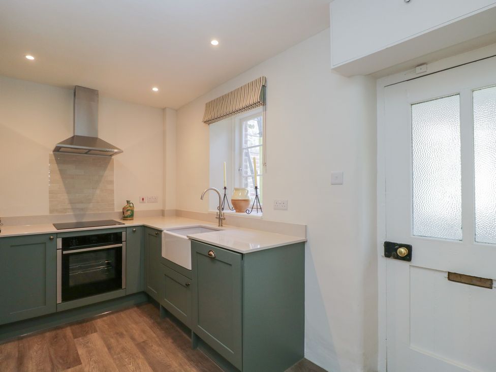A kitchen with a sink and oven at Middle Cottage Tisbury, Wiltshire