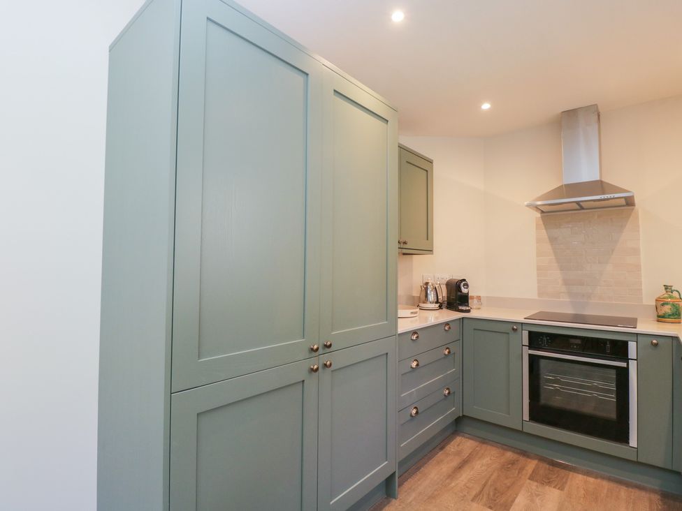 A kitchen with cabinets and appliances at Middle Cottage Tisbury, Wiltshire