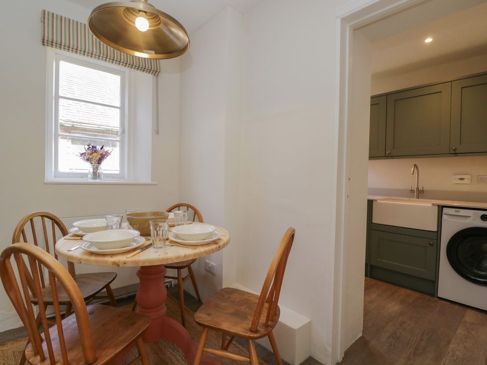 A dining room with a table and chairs at Middle Cottage in Tisbury, Wiltshire