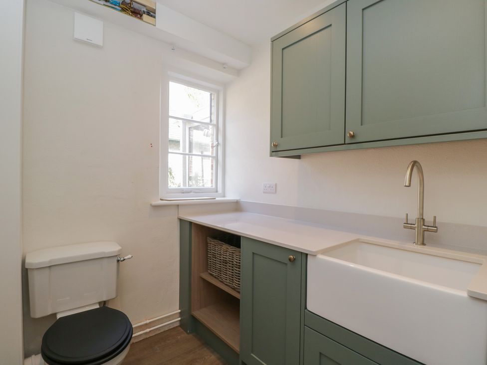 A bathroom with a sink and cupboard at Middle Cottage Tisbury, Wiltshire
