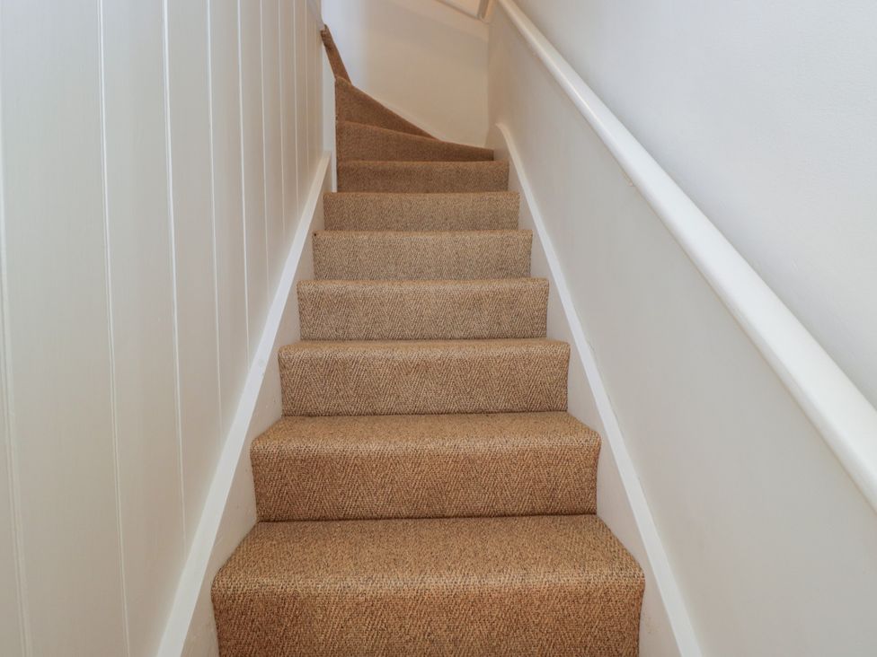 A staircase with carpet and handrail at Middle Cottage Tisbury Wiltshire