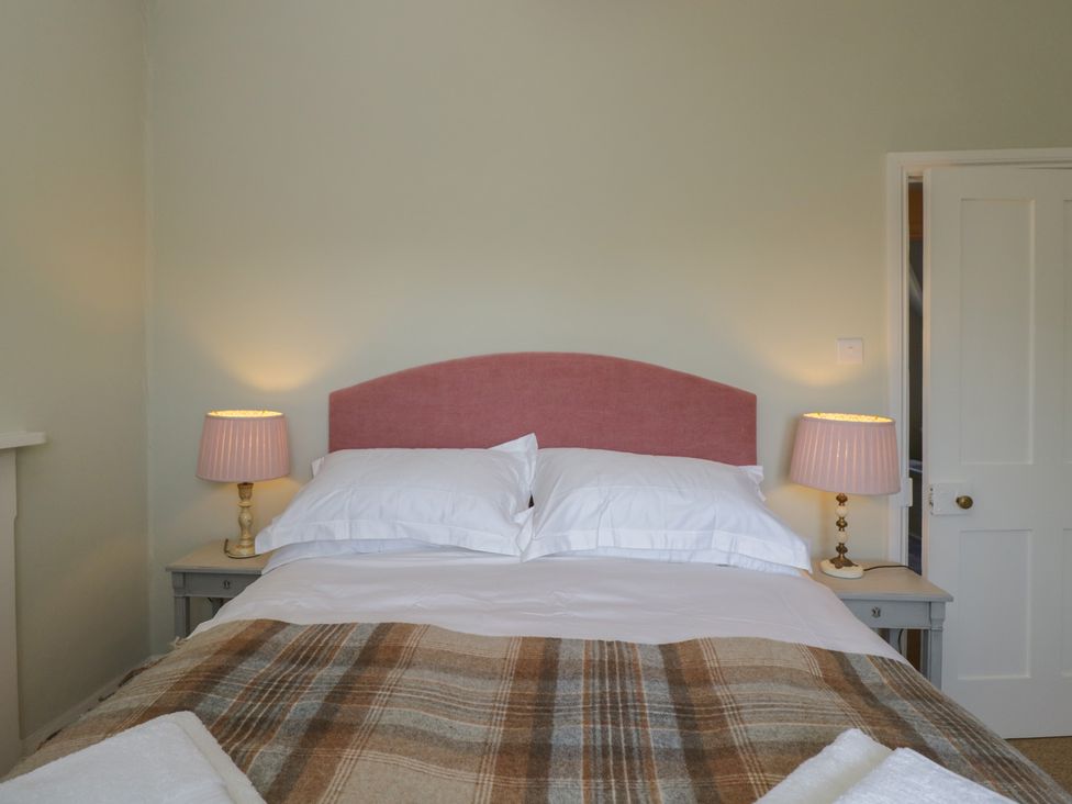 A bedroom with a bed and bedside tables at Middle Cottage Tisbury, Wiltshire