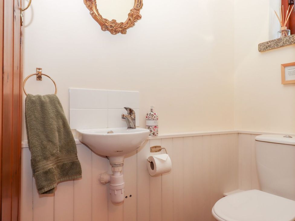 A bathroom with a sink and toilet at The Cottage in Sampford Courtenay
