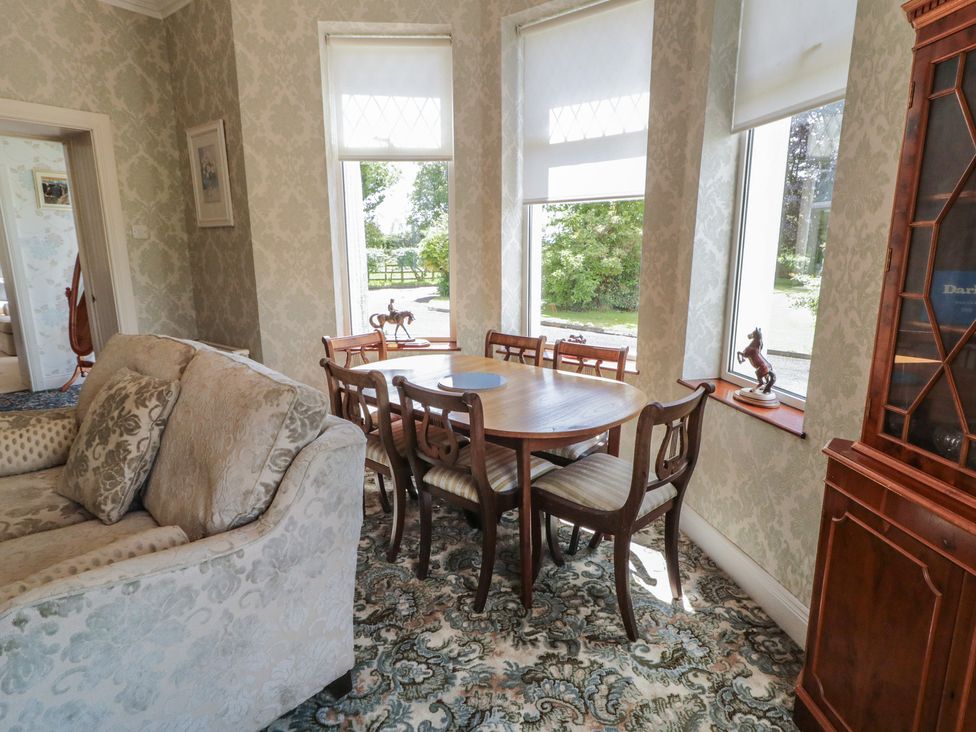 A dining room with a table and chairs at Riverdene in Mountjoy